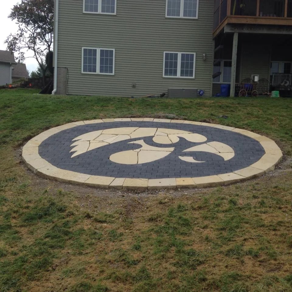 Custom Hawkeye paver medallion inlaid patio — Iowa City, IA